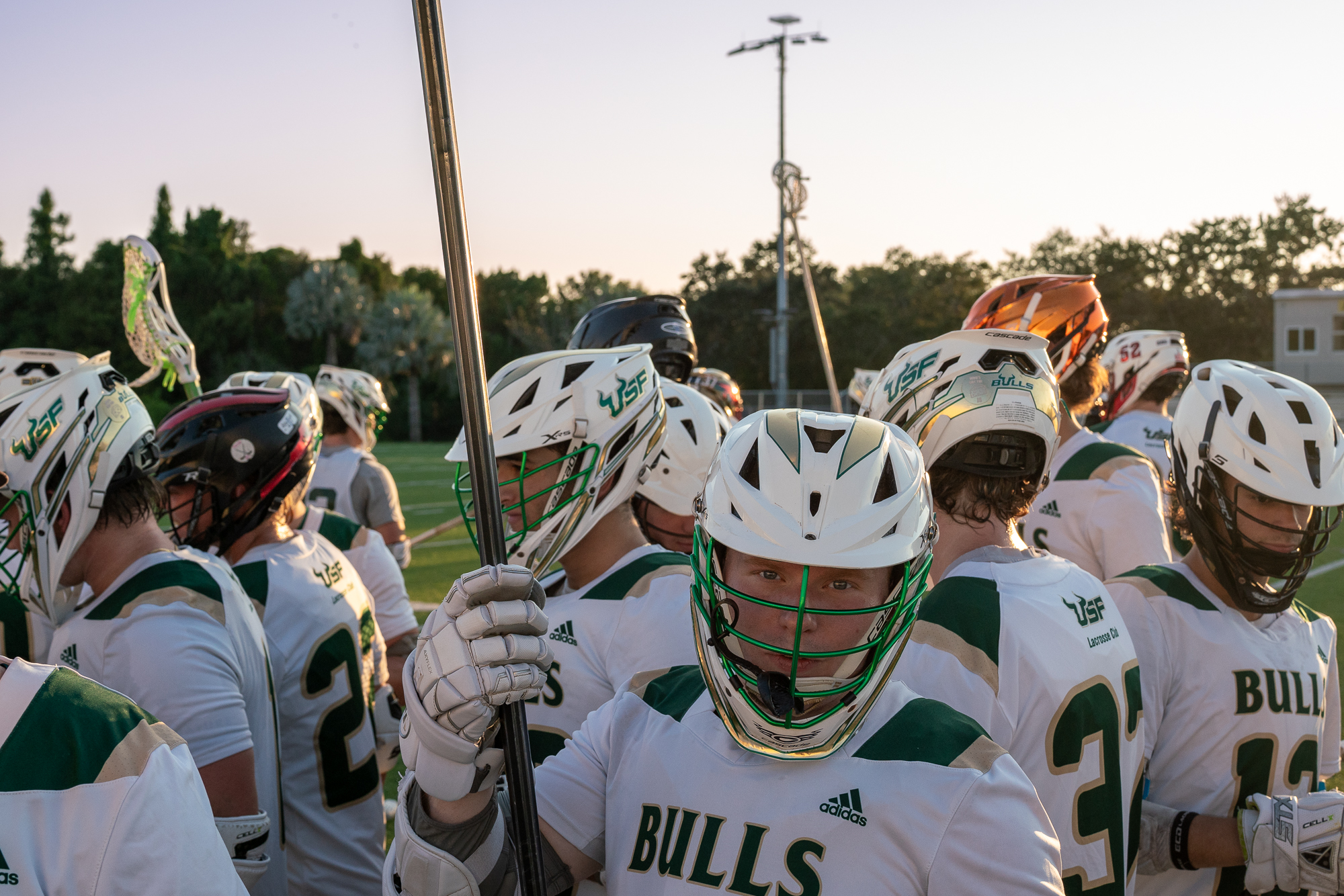 Lacrosse players in a huddle